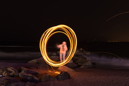 Showers of hot glowing sparks from spinning steel wool at Coney Island Beach, Brooklyn, New York.の写真素材
