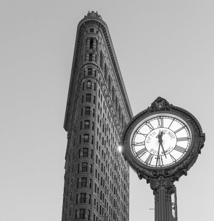 NEW YORK, NEW YORK - JANUARY 31, 2015: Flatiron Buliding and Fifth Avenue Clock. Completed in 1902, it is considered to be one of the first skyscrapers ever built.のeditorial素材