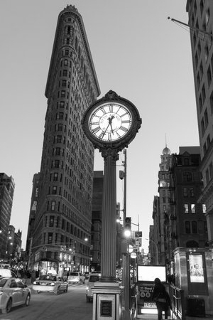 NEW YORK, NEW YORK - JANUARY 31, 2015: Flatiron Buliding and Fifth Avenue Clock. Completed in 1902, it is considered to be one of the first skyscrapers ever built.のeditorial素材