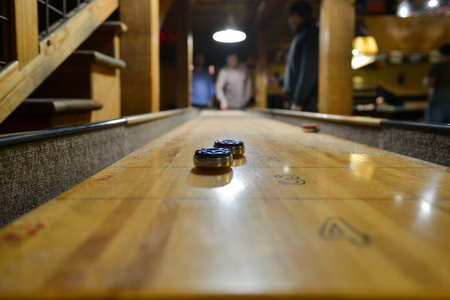 AUSTIN, TEXAS - MARCH 6, 2014: Table Shuffleboard at Buffalo Billiards in Austin, Texas.