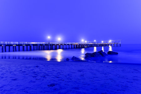 Pier and rocks on the beach. View from Coney Island Beach, Brooklyn, New York.の写真素材