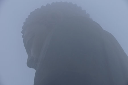 Tian Tan Buddha of Hong Kong shrouded in fog.の写真素材