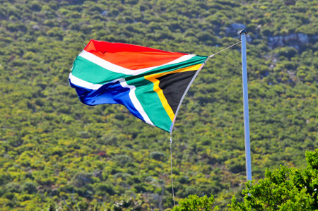 South African Flag fluttering in the wind along the coast of Cape Town, South Africa.の写真素材