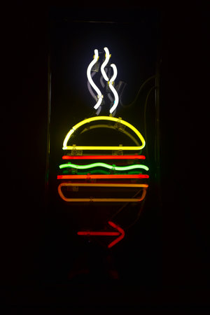 Neon Light Hamburger Restaurant Sign with arrow pointing.の写真素材