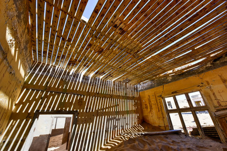 The abandoned ghost diamond town of Kolmanskop in Namibia, which is slowly being swallowed by the...