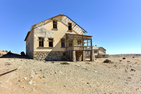 The abandoned ghost diamond town of Kolmanskop in Namibia, which is slowly being swallowed by the...