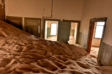 The abandoned ghost diamond town of Kolmanskop in Namibia, which is slowly being swallowed by the desert.の写真素材