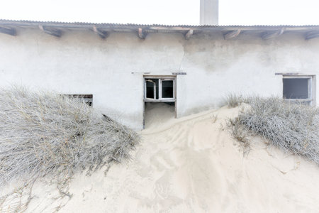 The abandoned ghost diamond town of Kolmanskop in Namibia, which is slowly being swallowed by the desert.の写真素材