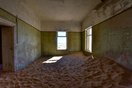 The abandoned ghost diamond town of Kolmanskop in Namibia, which is slowly being swallowed by the desert.の写真素材