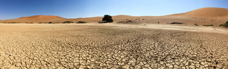 Sossusvlei (sometimes written Sossus Vlei) is a salt and clay pan surrounded by high red dunes, located in the southern part of the Namib Desert, in the Namib-Naukluft National Park of Namibia.の写真素材