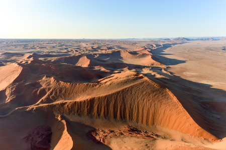 Aerial view of high red dunes, located in the Namib Desert, in the Namib-Naukluft National Park of Namibia.の写真素材