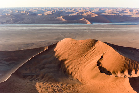 Aerial view of high red dunes, located in the Namib Desert, in the Namib-Naukluft National Park of Namibia.の写真素材