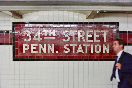 New York City - October 7, 2015: Businessman walking through the 34th Street Pennsylvania Station Subway stop in New York City.のeditorial素材