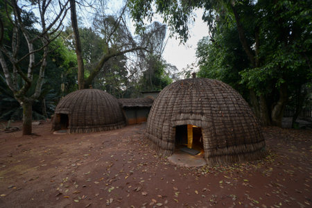 Sunset in Mlilwane Game Reserve with a traditional Swazi hutの写真素材