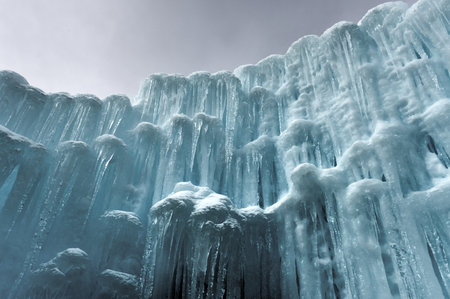 Translucent blue icicles in a frozen ice wall.