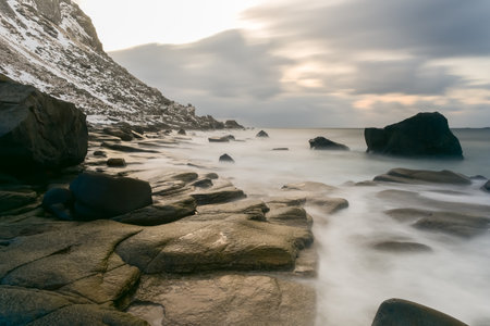 Waves flowing over Utakleiv Beach, Lofoten Islands, Norway in the winter.の写真素材