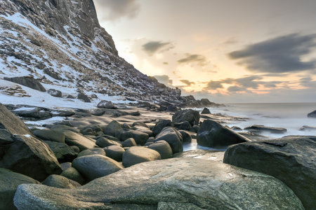 Waves flowing over Utakleiv Beach, Lofoten Islands, Norway in the winter.の写真素材