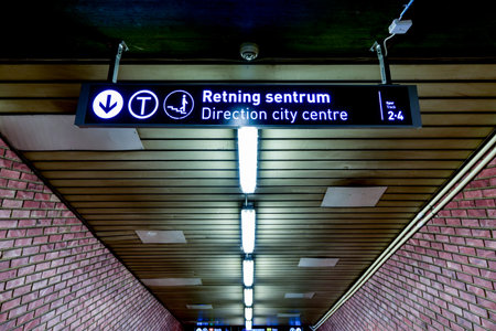 Oslo, Norway - February 28, 2016: Oslo subway (Norwegian T-banen i Oslo). Sign leading to the city centre.のeditorial素材