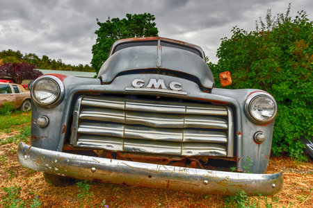 Rusting old GMC car in a desert junk yard.のeditorial素材