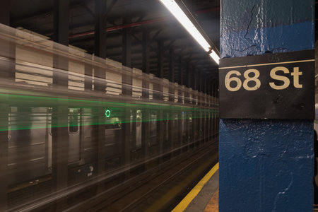 New York City - November 18, 2016: Six train running through Sixty Eighth Street Subway station on the East Side of Manhattan, New York City.のeditorial素材