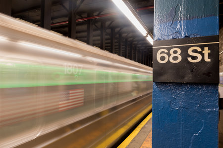 New York City - November 18, 2016: Six train running through Sixty Eighth Street Subway station on the East Side of Manhattan, New York City.のeditorial素材