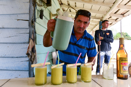 Manaca Iznaga, Cuba - Jan 12, 2017: Cuban man selling sugar cane juice (guarapo) in Manaca Iznaga,...