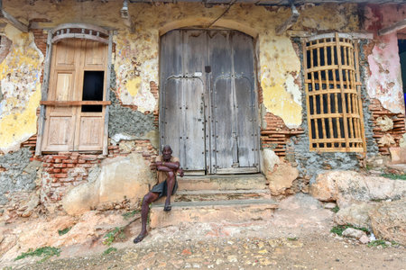 Trinidad, Cuba - January 12, 2017: Old man sitting in the colonial town of Trinidad in Cuba, a UNESCO World Heritage site.のeditorial素材