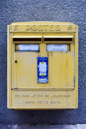 Yellow French Post Box in Bourges, France. Labeled "Posts" it asks not to throw newspapers into the box.の写真素材
