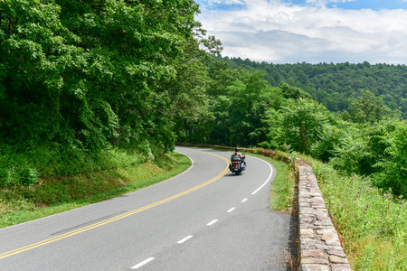 Motorcycle driving along Skyline Drive in the Shenandoah Valley and Blue Ridge Mountains from Shenandoah National Park, Virginiaの写真素材