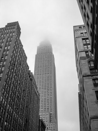 Empire State Building in New York City shrouded in fog (black and white).のeditorial素材