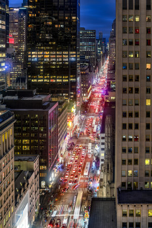 New York City skyline in midtown Manhattan as cars drive through the city in the evening.