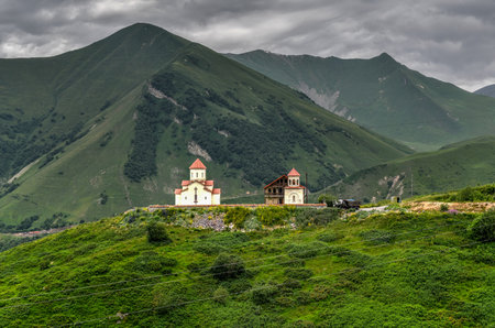 Amaglebis Church in the green mountain landscape of Ganisi, Georgia.
