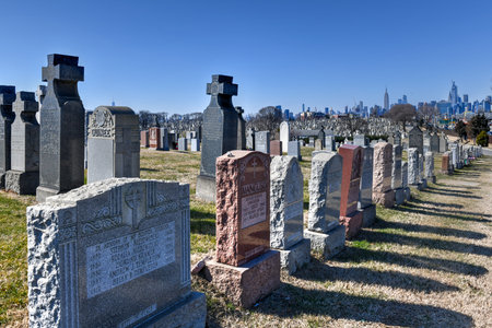 New York City - Feb 23, 2020:  Calvary Cemetery with Manhattan skyline in New York. Calvary Cemetery...