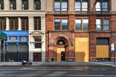 New York City, New York - June 11, 2020: Store closed during the COVID-19 pandemic, with boarded up...