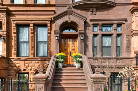 New York City - Apr 10, 2021: View of Brownstone buildings in Harlem in Manhattan, New York City.