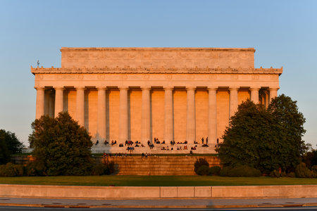 Washington, DC - Apr 3, 2021: Lincoln Memorial from the rear with spectators enjoying the sunset in Spring in Washington, DCのeditorial素材