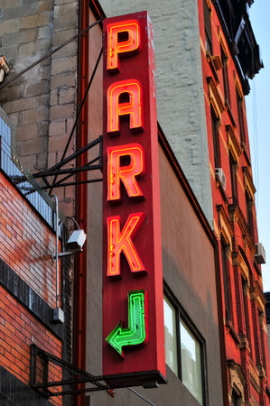 Vintage neon parking sign at the entrance of a parking lot in New York Cityのeditorial素材