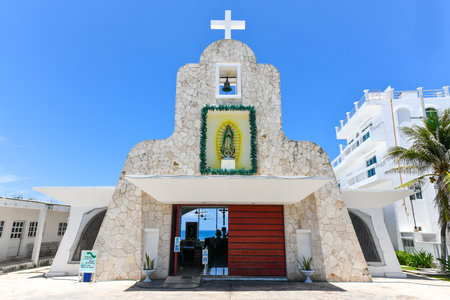 Chapel of Guadalupe in Island Mujeres, Mexico with a panoramic view of the sea behind it.
