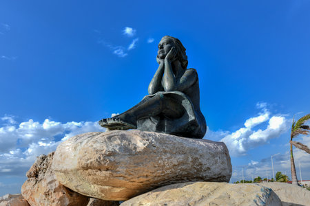 Campeche, Mexico - May 25, 2021: Statue of girl known as Bride of the Sea looking at sea on Malecon in center of Campeche, beautiful historic colonial city in Yucatan, Mexico on sunny day.のeditorial素材
