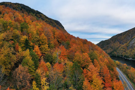Peak fall foliage in Keene, New York by Cascade Lake.の写真素材