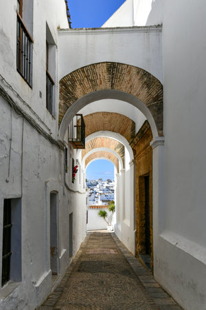 Arches of the Jewish quarter in the historical center of the white beautiful village of Vejer de la Frontera on a sunny day, Cadiz province, Andalusia.の写真素材