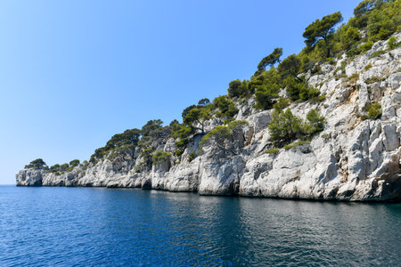 Calanque de Figuerolles, a snug cove framed by rugged cliffs in France.