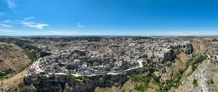 The steep cliffs and canyons and the ancient Madonna de Idris rock church in the city of Matera,...