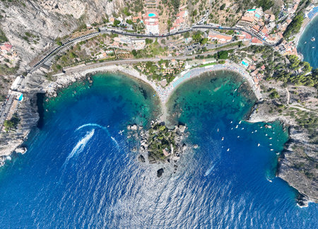 Aerial view of the beach of Taormina in the blue waters of the Ionian Sea in Sicily, Italy.の写真素材