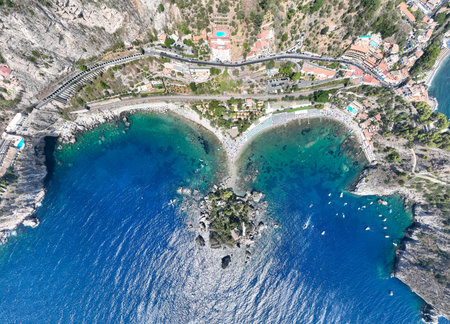 Aerial view of the beach of Taormina in the blue waters of the Ionian Sea in Sicily, Italy.の写真素材