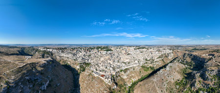 Aerial view of the ancient town of Matera (Sassi di Matera) in beautiful Basilicata, southern Italy. ancient cave houses carved into the tufa rock over the deep ravine, Gravina River.の写真素材