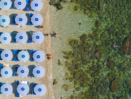 Aerial view of the beach of Taormina in the blue waters of the Ionian Sea in Sicily, Italy.の写真素材