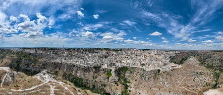 Aerial view of the ancient town of Matera (Sassi di Matera) in beautiful Basilicata, southern Italy. ancient cave houses carved into the tufa rock over the deep ravine, Gravina River.の写真素材