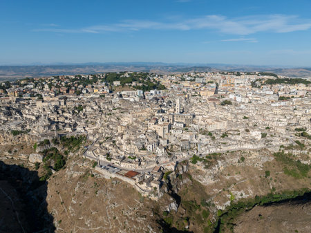 Aerial view of the ancient town of Matera (Sassi di Matera) in beautiful Basilicata, southern Italy. ancient cave houses carved into the tufa rock over the deep ravine, Gravina River.の写真素材
