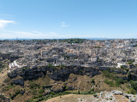 The steep cliffs and canyons and the ancient Madonna de Idris rock church in the city of Matera,...
